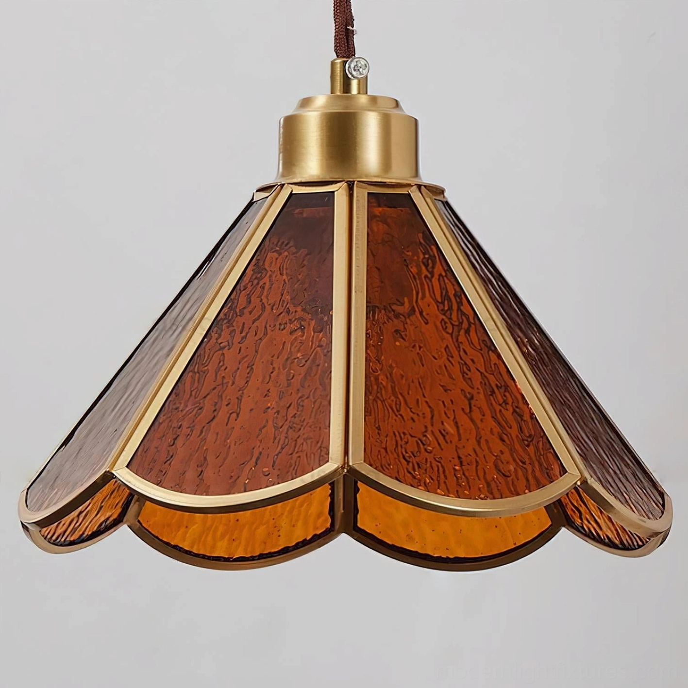 Tavelle wall sconce full view showing curved bronze arm and artistic petal lampshade design