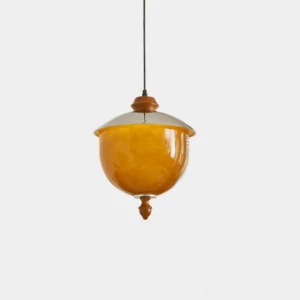 Tavira vintage pendant light with caramel glass globe and chrome metal cap displayed in studio lighting