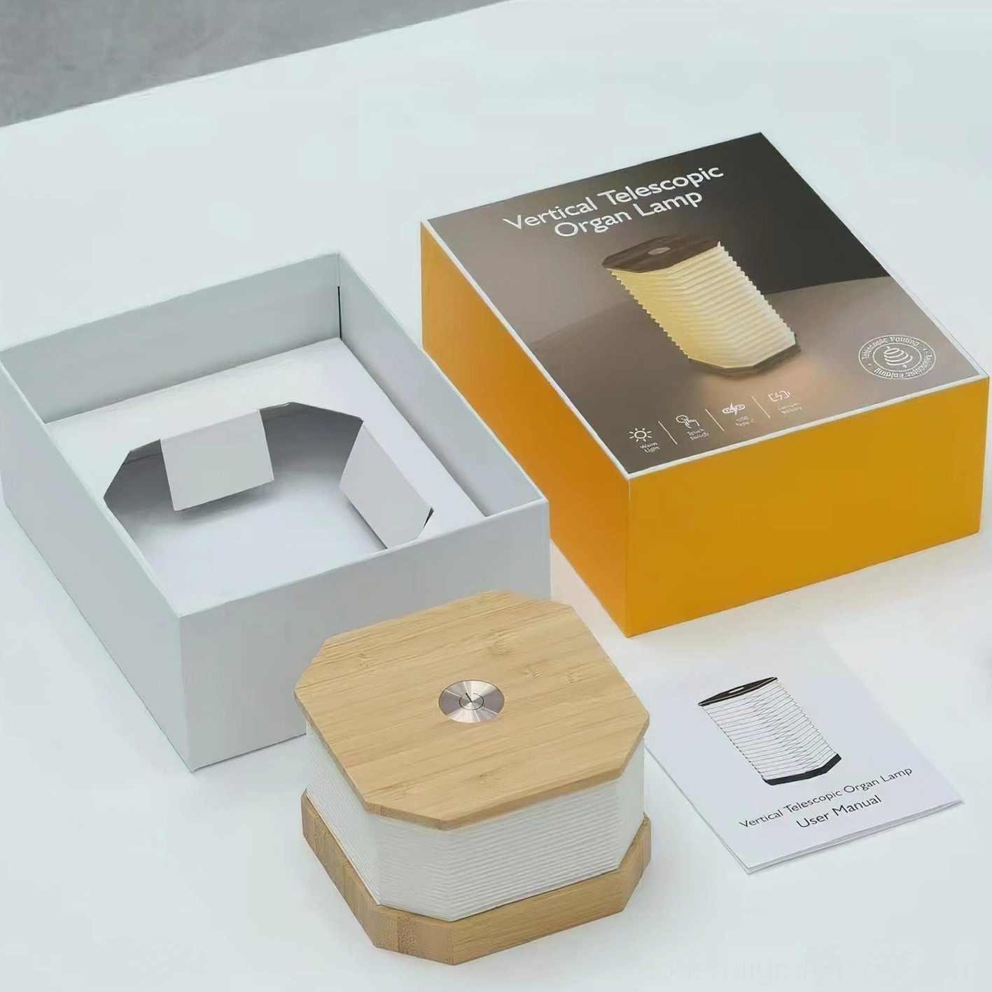 Tawa Fold accordion table lamp unboxing flat lay showing product packaging and bamboo wood base