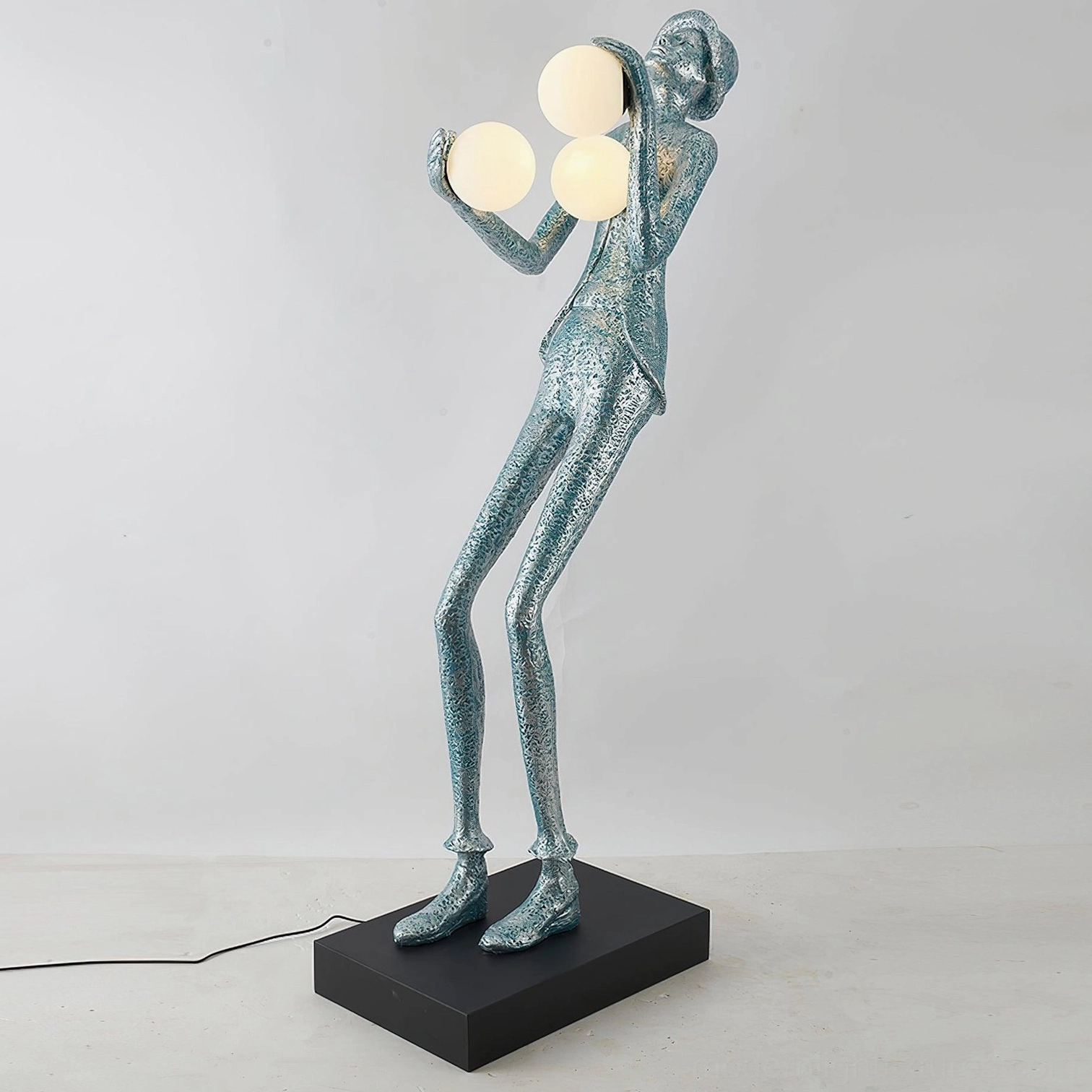 Teal blue humanoid sculptural floor lamp with frosted glass orbs in stylish modern interior setting