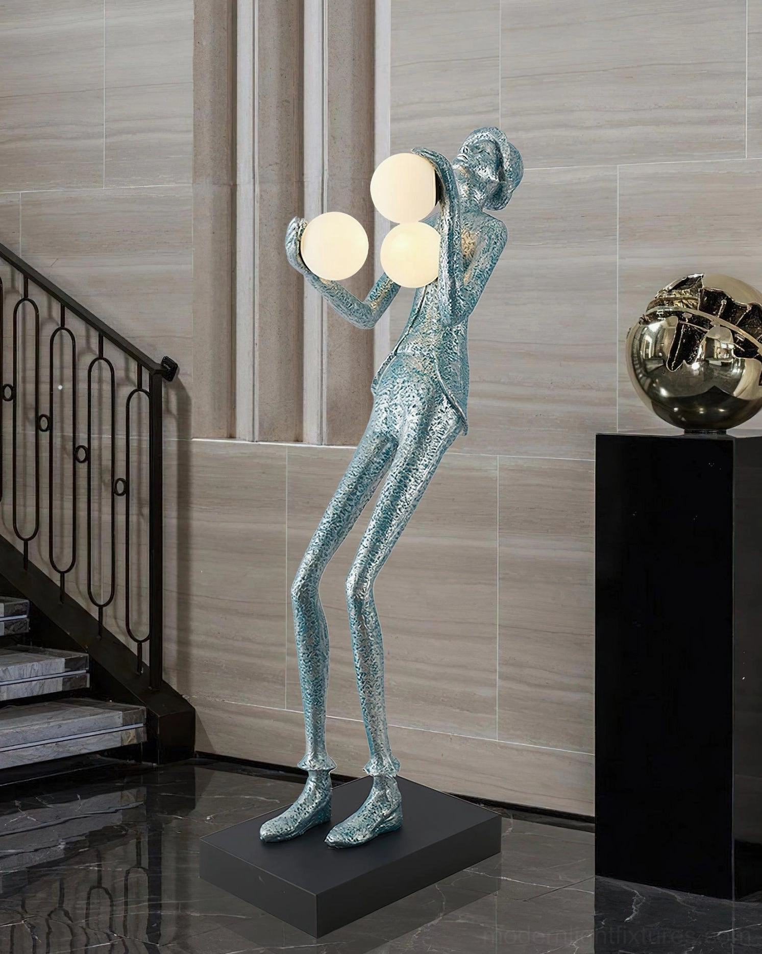 Teal blue textured resin humanoid sculptural floor lamp with three frosted globe lights in contemporary stairwell interior