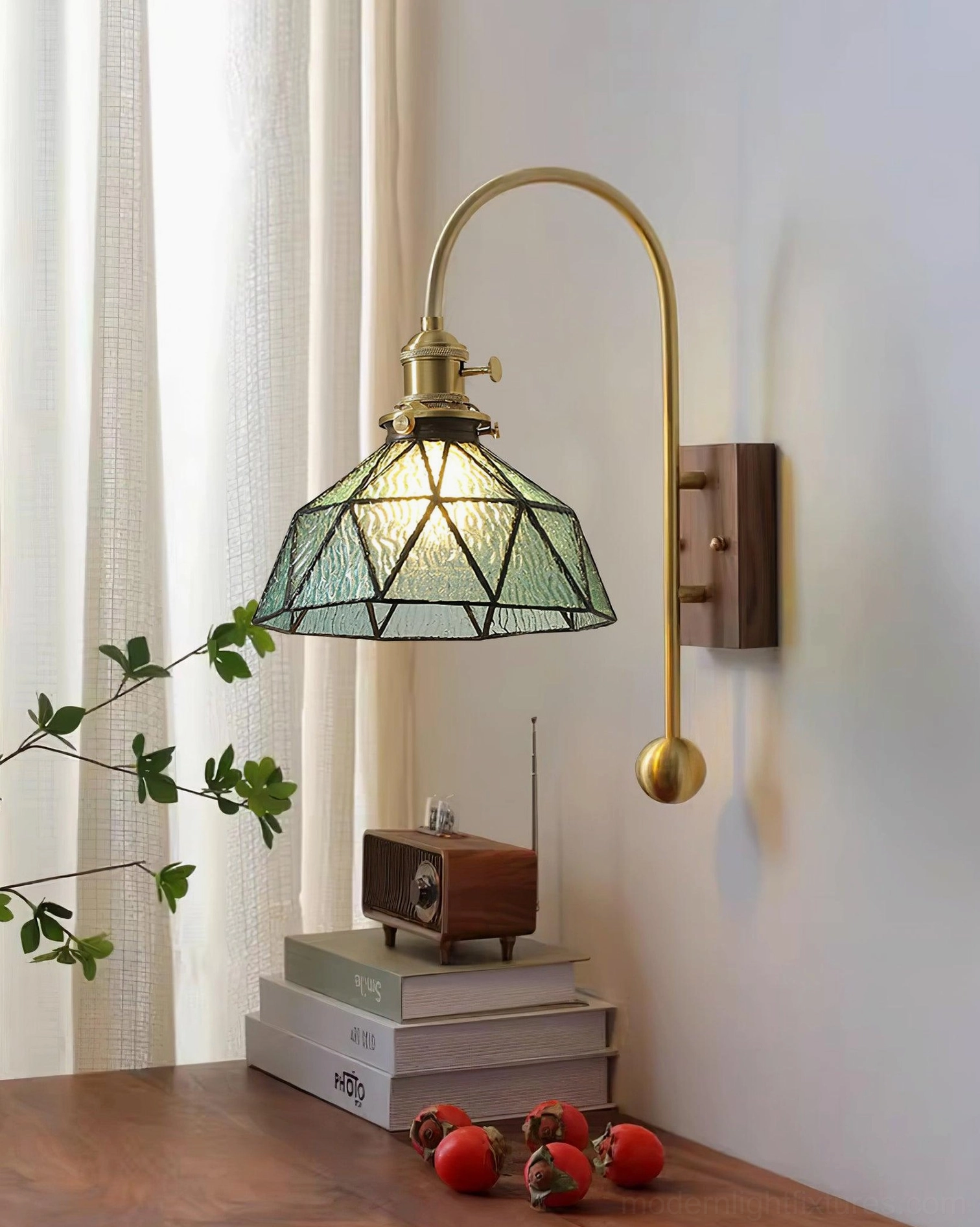 Teal geometric stained glass wall sconce with brass arm and walnut base in botanical decor setting