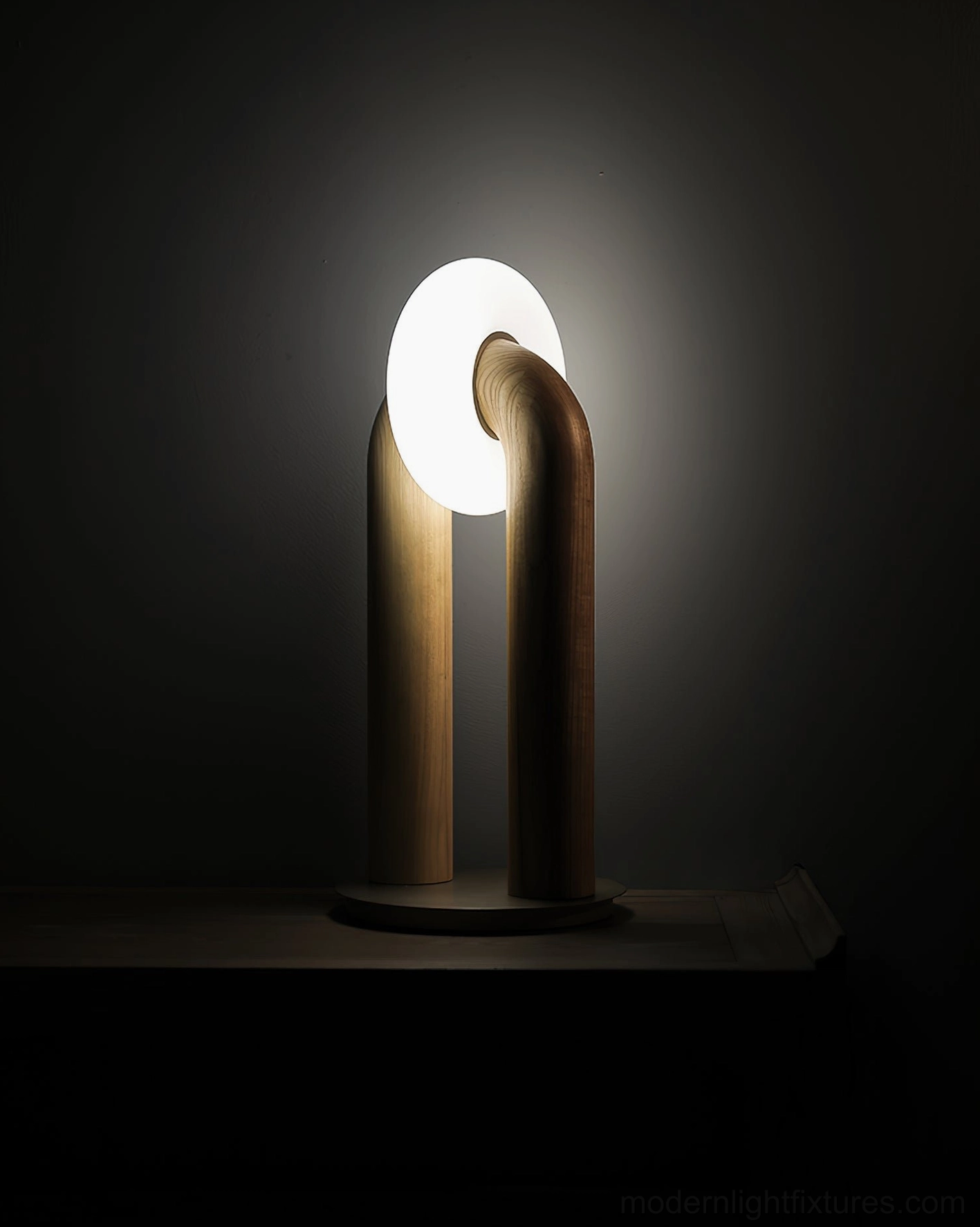 Lit Teelo table lamp with frosted shade glowing warm amber light, low angle perspective in dim indoor setting