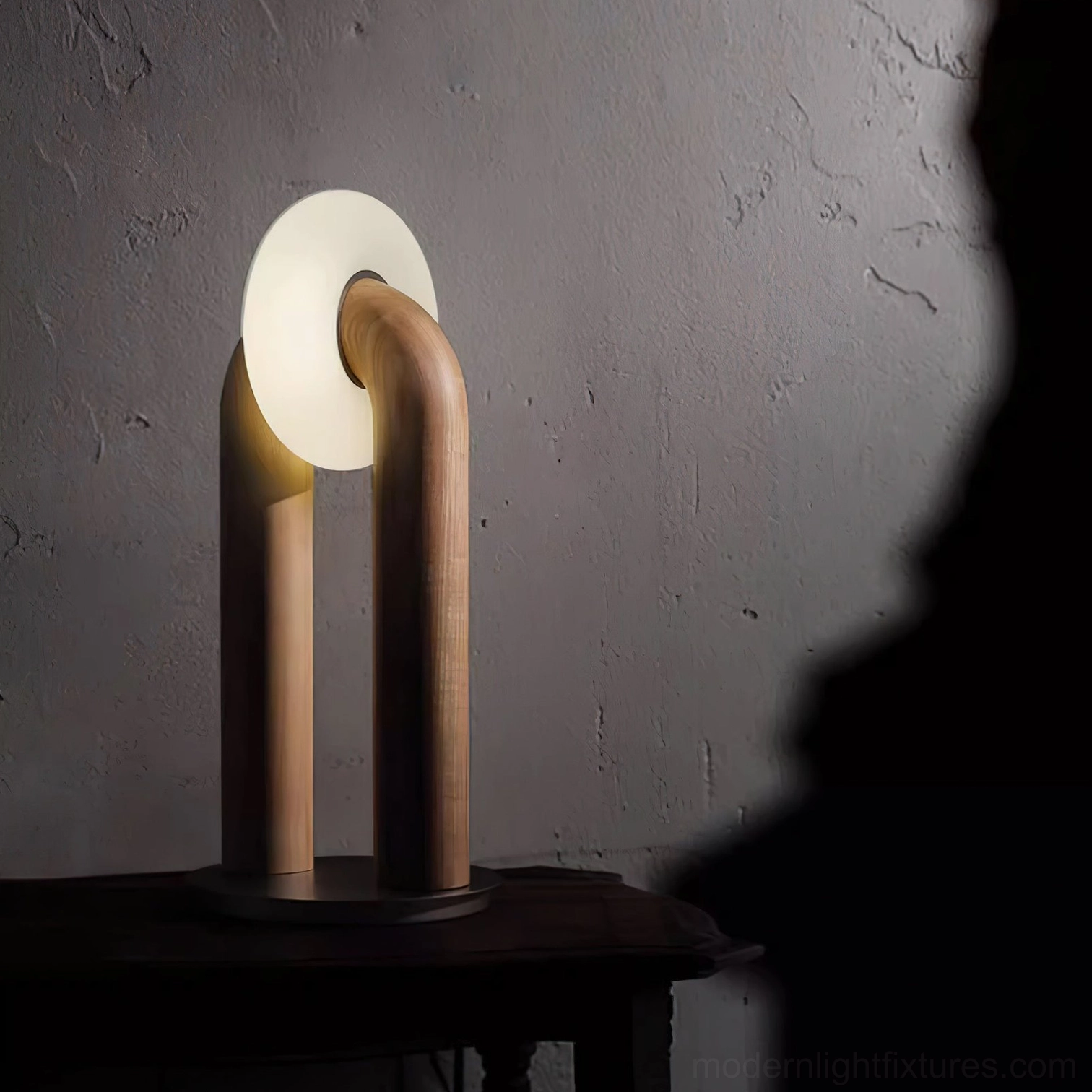 Walnut finish Teelo table lamp with milky white shade on small dark side table, warm ambient home lighting corner
