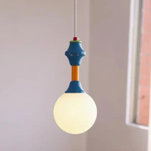 Tende retro pendant lamp hanging in bright indoor space with natural light showing blue yellow red color segments