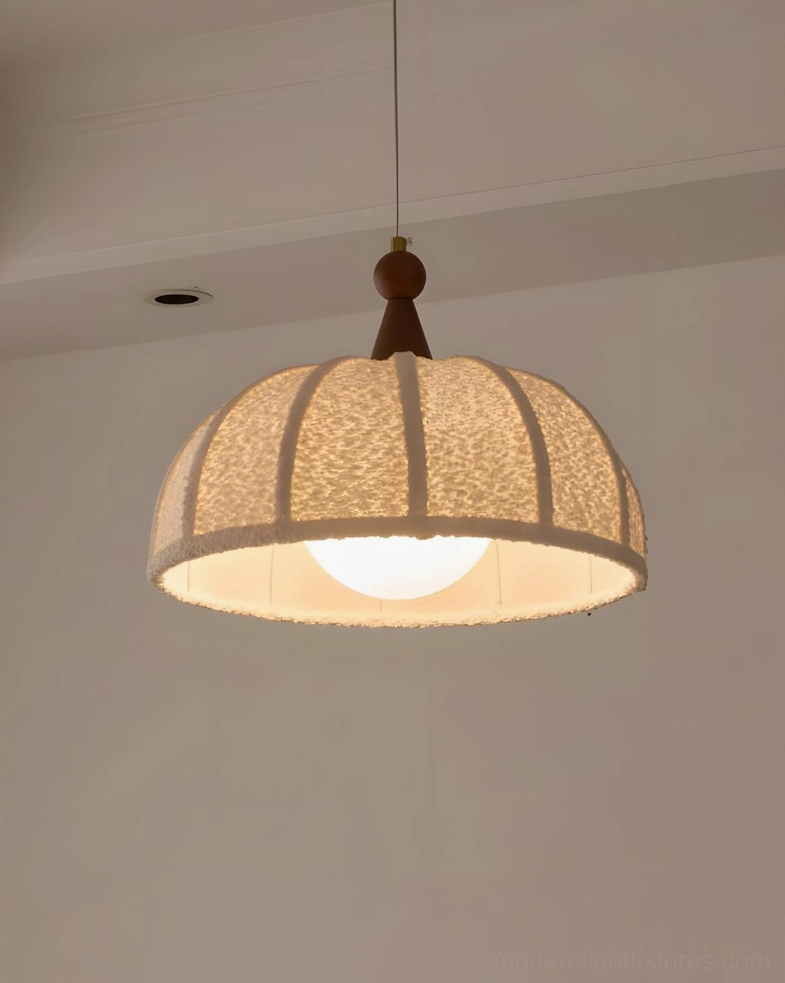 Tenera pendant light showing walnut wood accent detail and ribbed fabric construction