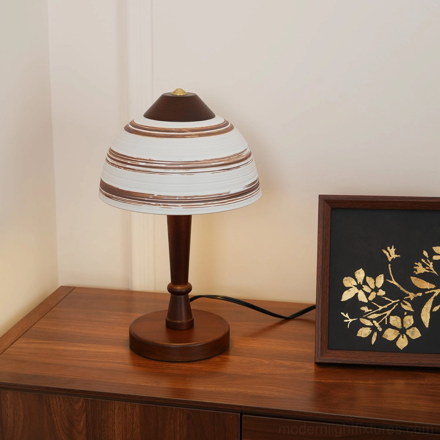 Tera mid-century table lamp left close-up view with ceramic accents and framed wall art background