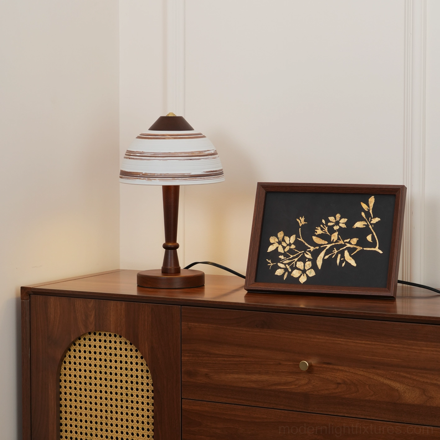 Tera table lamp side view showing cane webbing detail on adjacent cabinet and ceramic lamp accents