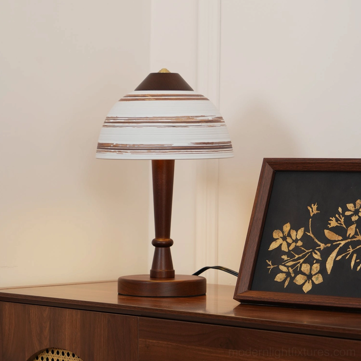 Tera wood and ceramic table lamp right three-quarter view in styled interior with dark furniture