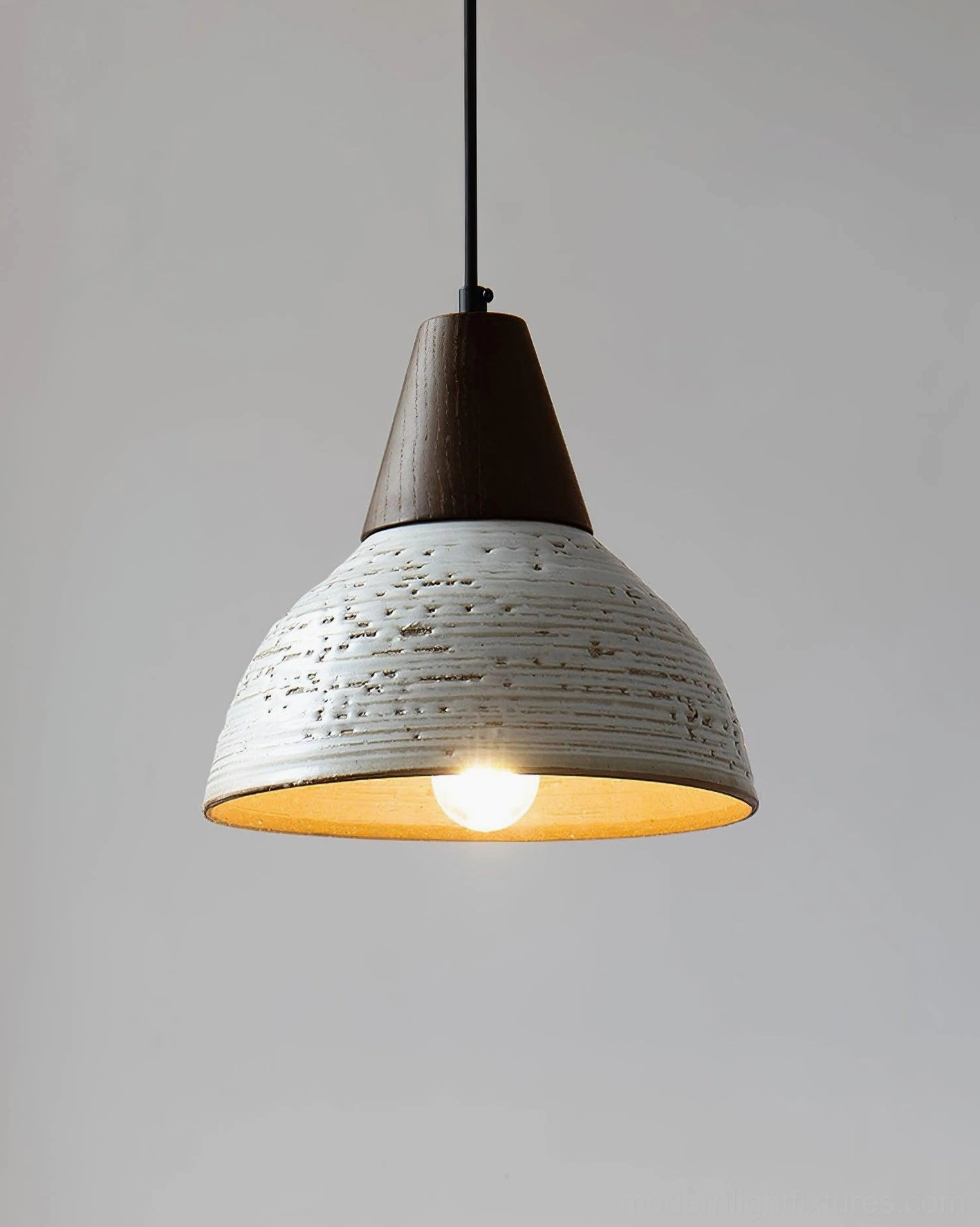 Tera pendant light fixture showing interior warm light diffusion and contemporary ceramic shade artisan craftsmanship
