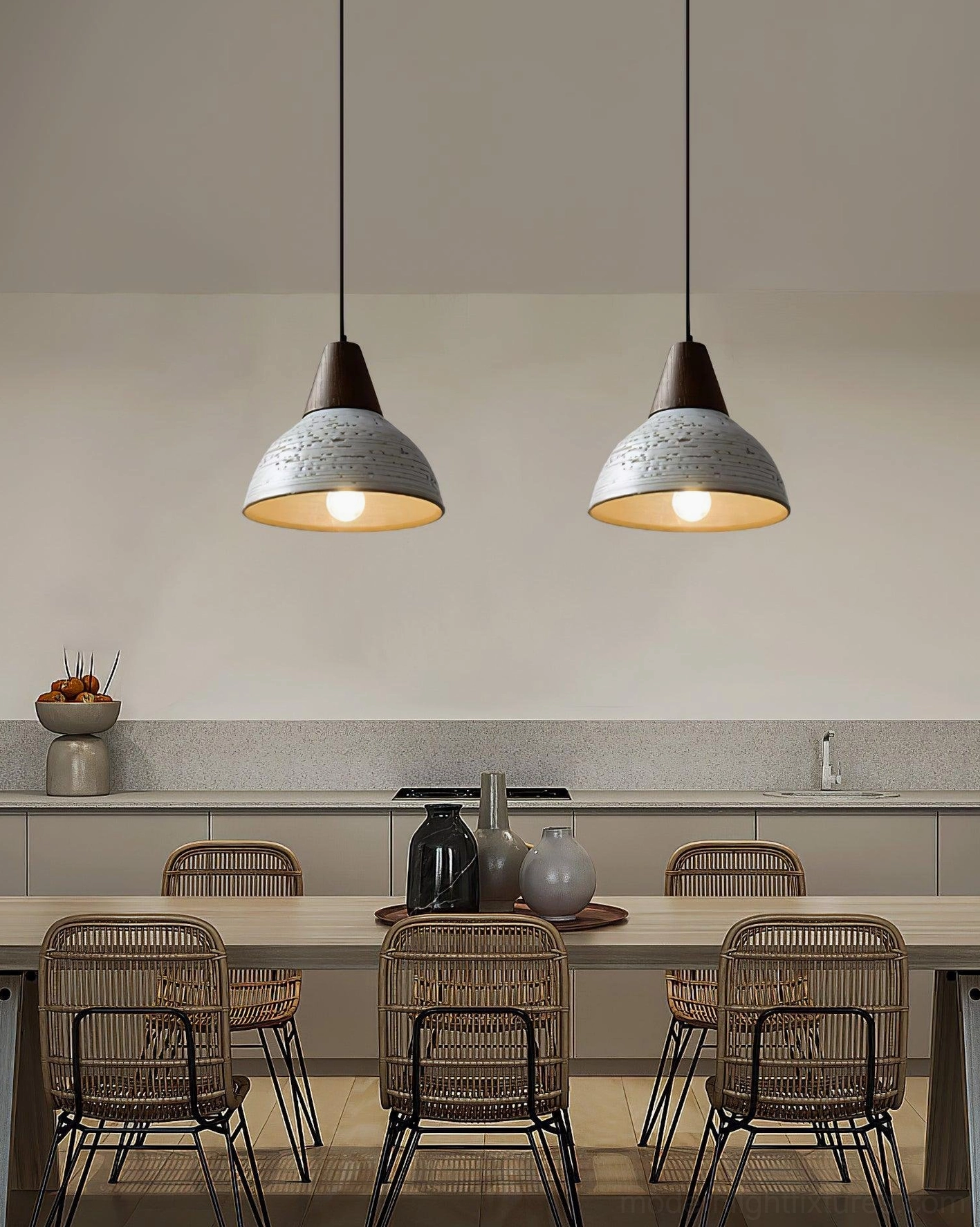 Pair of matching Tera pendant lights suspended in modern rustic dining room above wooden table with rattan chairs