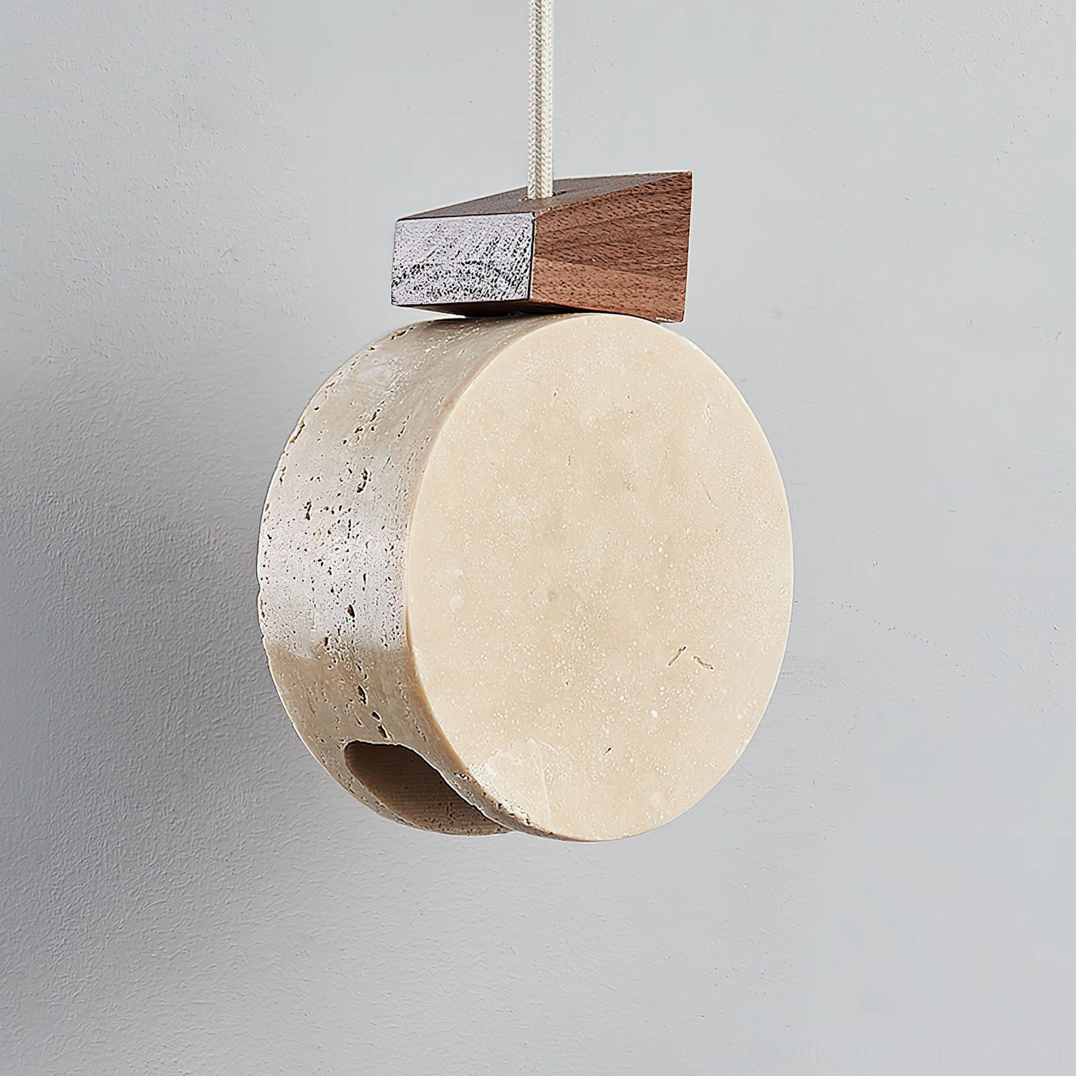 Terra Ring pendant light with dark walnut top close-up side view showing natural stone pores and suspension wire