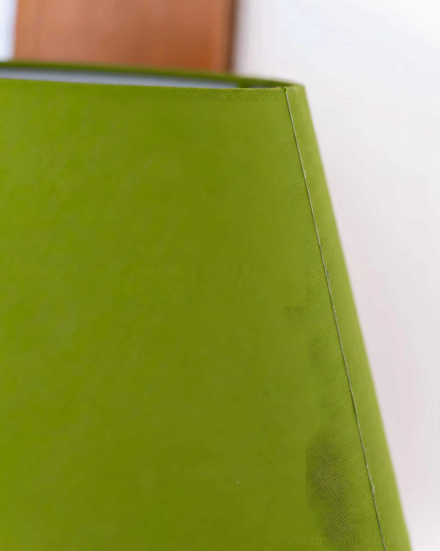 Terrava sculptural floor lamp with green fabric shade and brass metal stem in eclectic home design