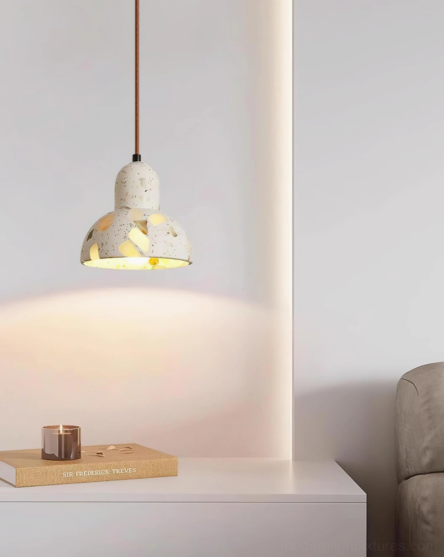 Terrazzo pendant light with brass fixtures showing stone texture and light filtration detail