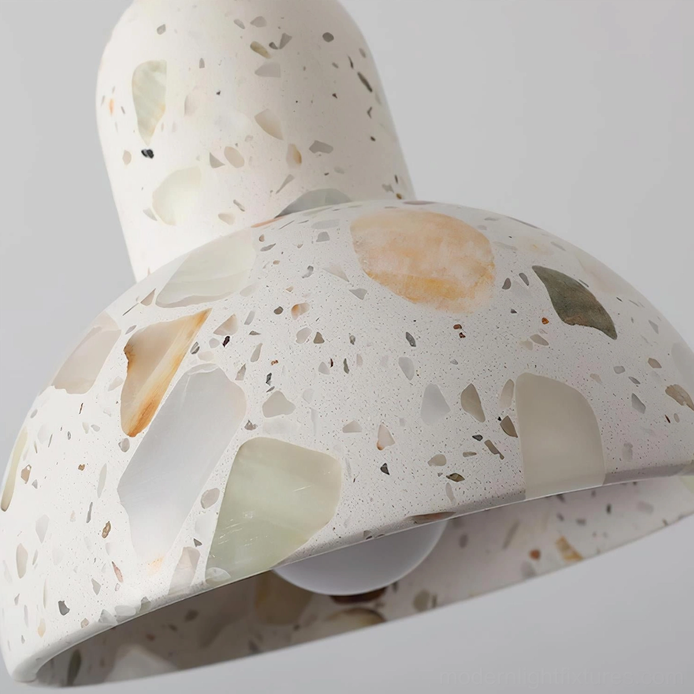 Terrazzo pendant light with warm ambient glow in contemporary interior decoration scheme