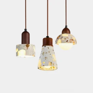 Three terrazzo pendant lights in different sizes and styles - conical, dome-shaped, and cylindrical shades with walnut wood accents