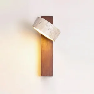 Tersus warm white wall sconce with natural travertine stone shade angled on wood base, studio lighting detail