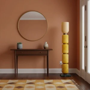 Tessara modern floor lamp in warm entryway setting with terracotta wall and round mirror, side angle view