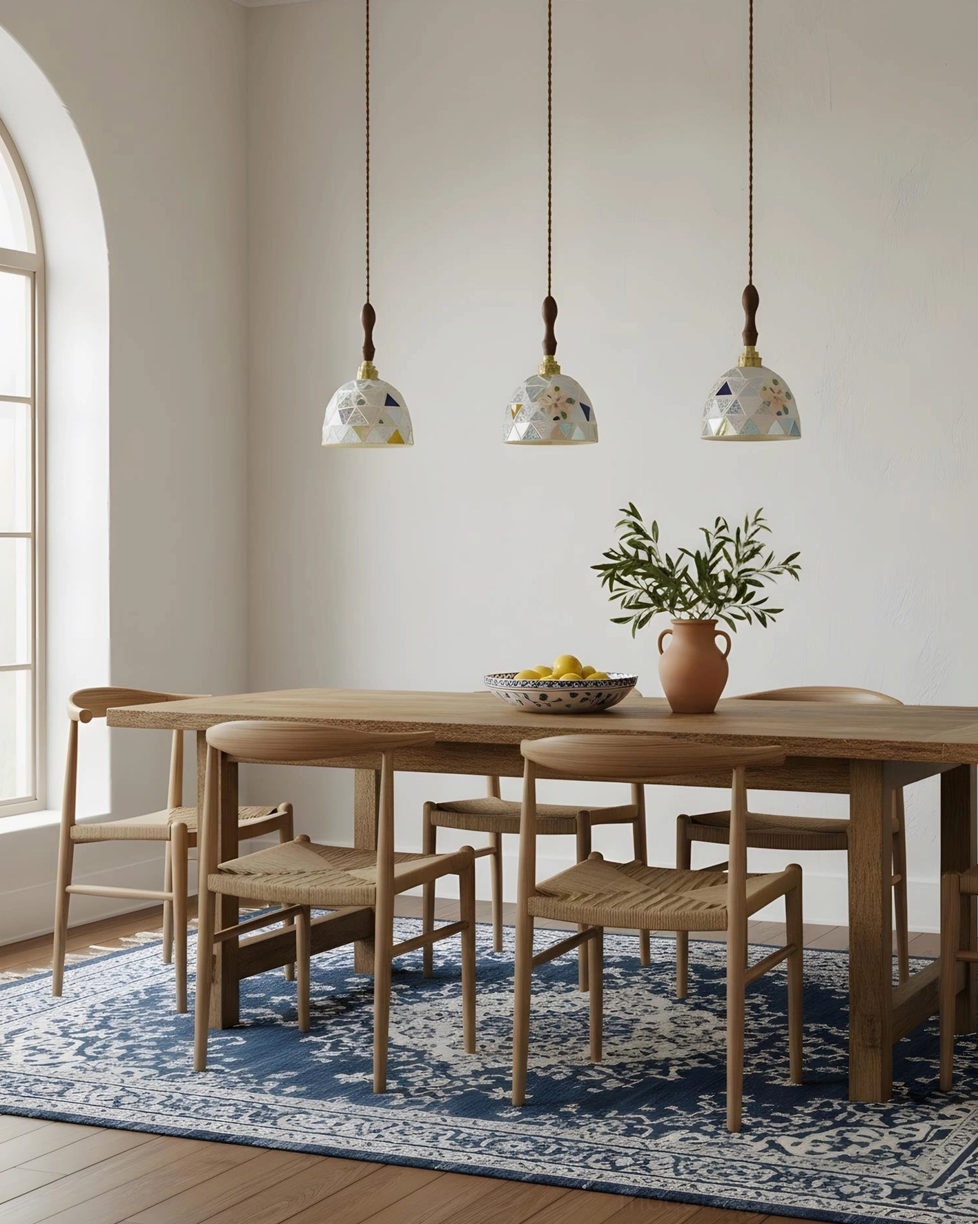 Three matching Tessaro embossed ceramic pendant lights above rustic wooden dining table