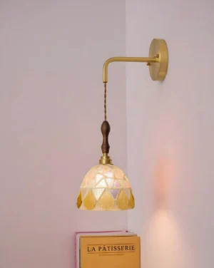 Tessaro wall sconce showing brass curved arm and wood accent detail, side profile perspective