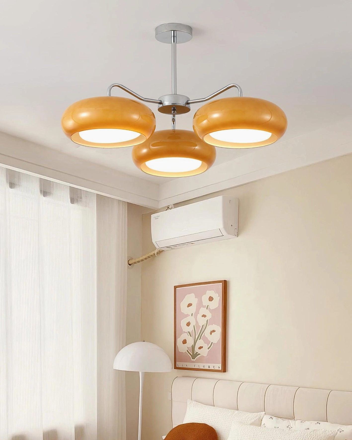 Tetra pendant chandelier with warm amber frosted glass shades in Nordic-decorated living room - intimate ambient lighting