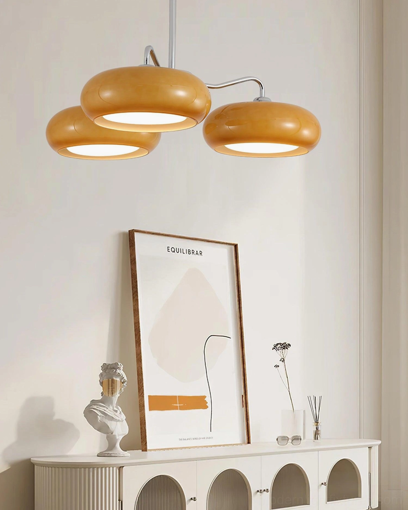 Tetra mid-century pendant chandelier with amber glass above decorative console table - side interior view