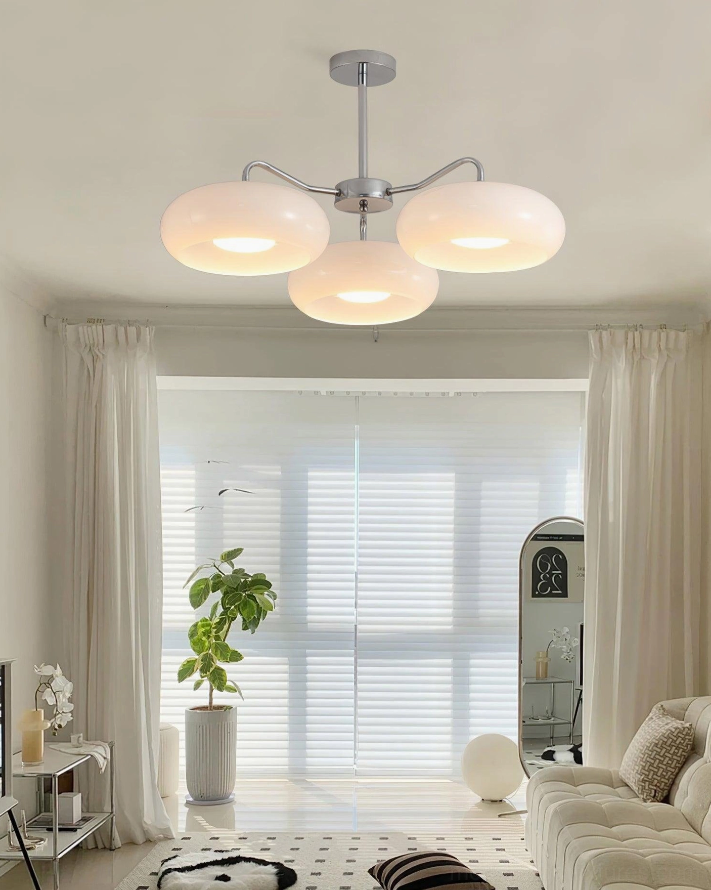 Tetra modern ceiling light installed in Scandinavian living room with white glass shades and silver hardware