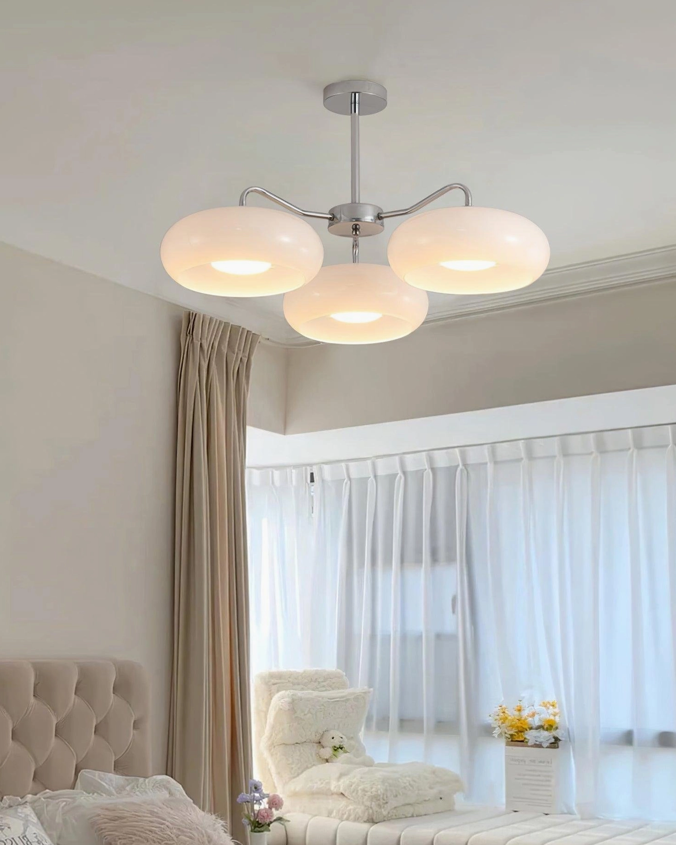 Tetra 3-light ceiling pendant with milky white frosted glass shades in cozy bedroom setting - warm ambient lighting