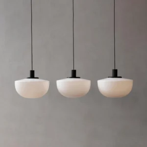 Modern pendant lighting fixtures - triple bank glass pendant lamps installed in minimalist setting