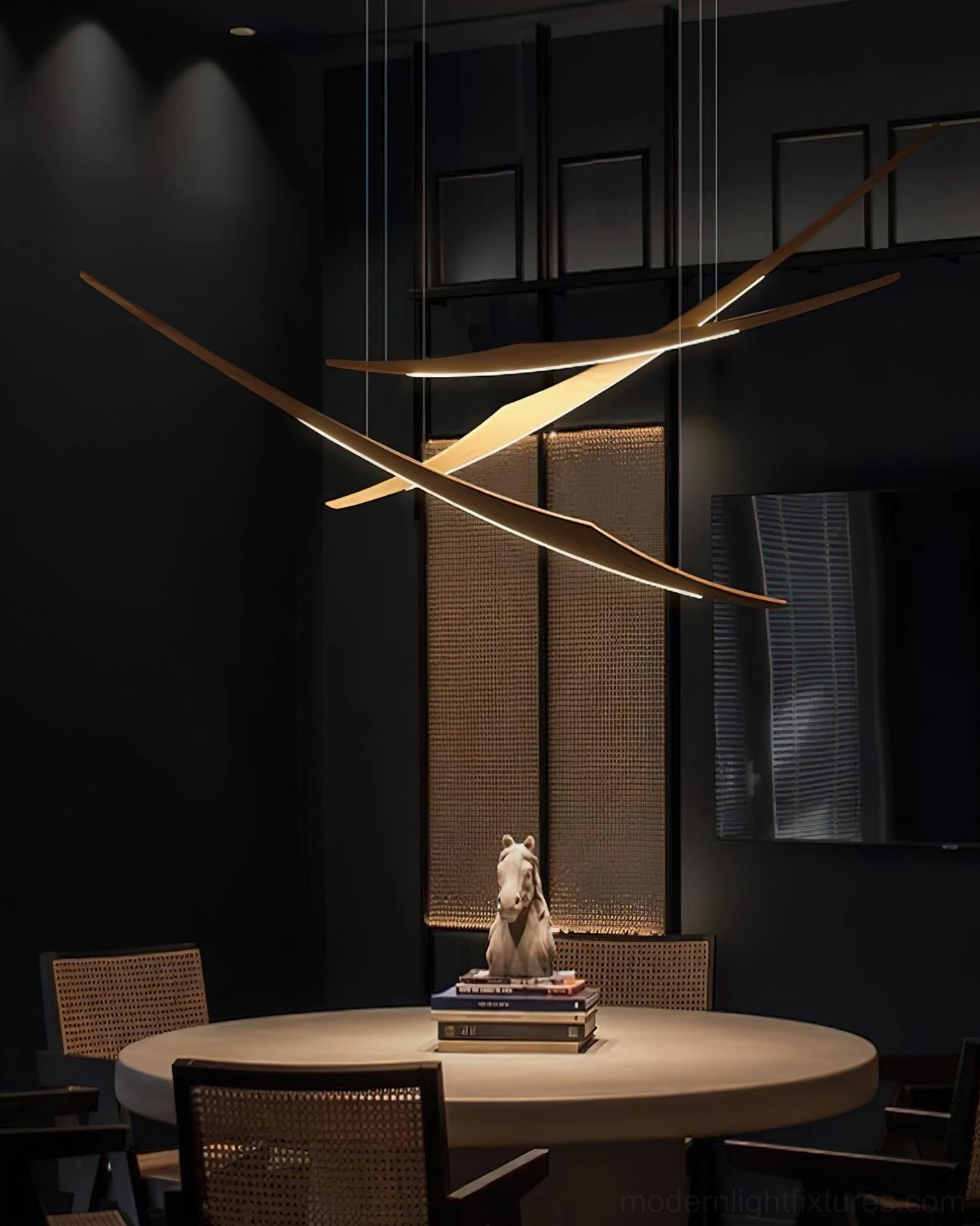 Triple arc pendant chandelier with decorative table setting in dark-toned residential dining area