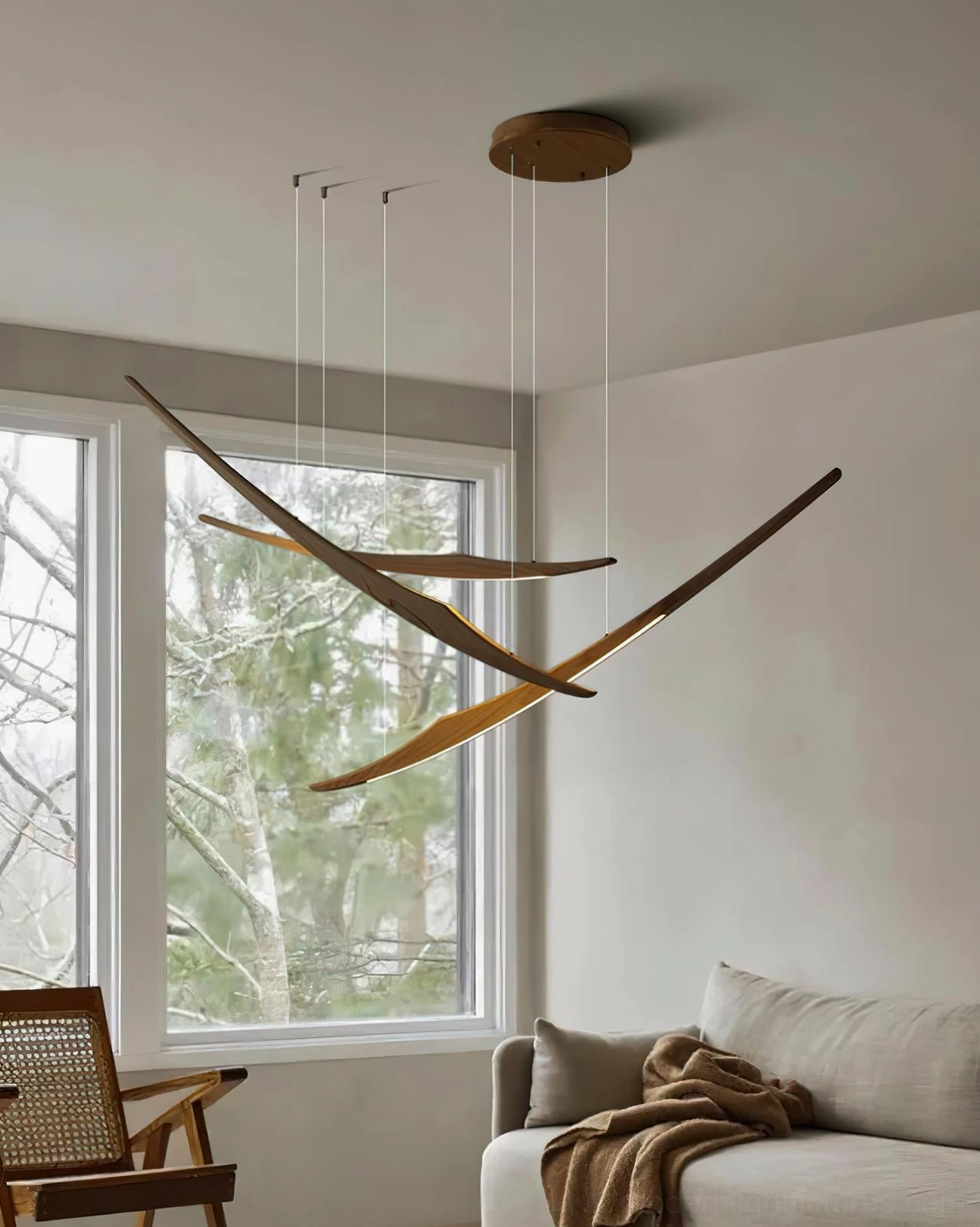 Three-head kinetic arc chandelier displaying balanced sculptural form and light distribution