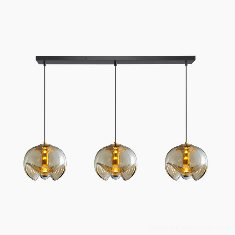 Three-head left configuration with amber-tinted wave glass shades, 23.6 inch span modern ceiling pendant lighting solution