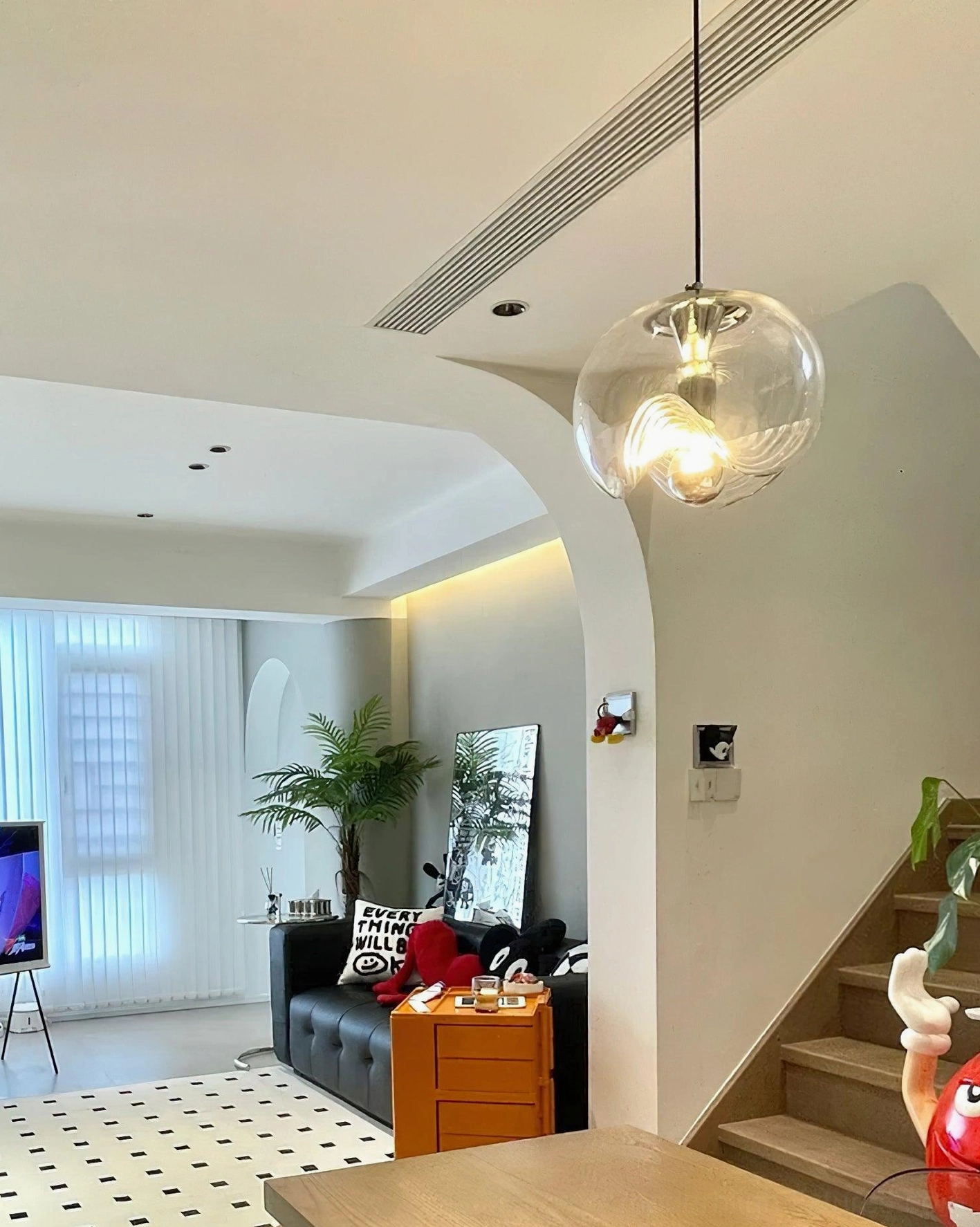 Three-head modern pendant light cluster in contemporary dining space, showcasing multiple wave glass shades for island lighting solution