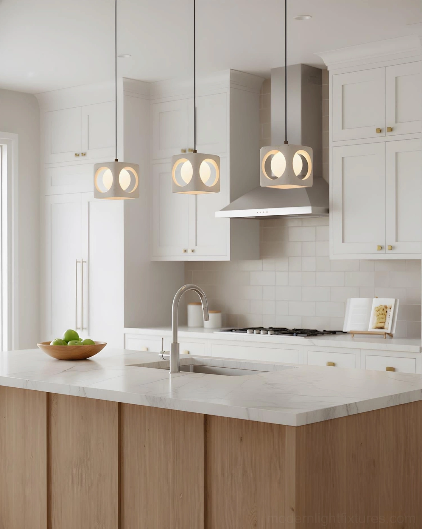 Three-head Hollowa travertine pendant light set installed above modern kitchen island with black cabinetry
