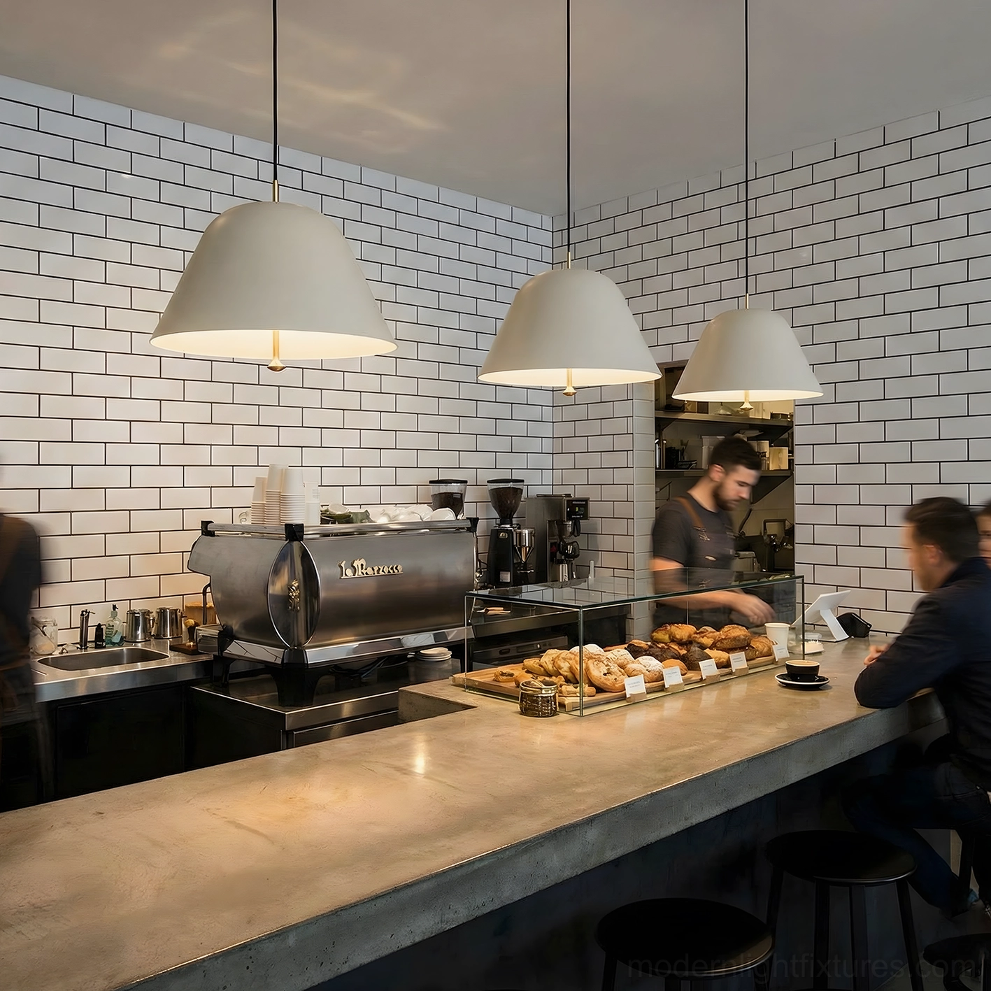 Three off-white dome pendant lights overhead view cafe counter industrial casual interior design