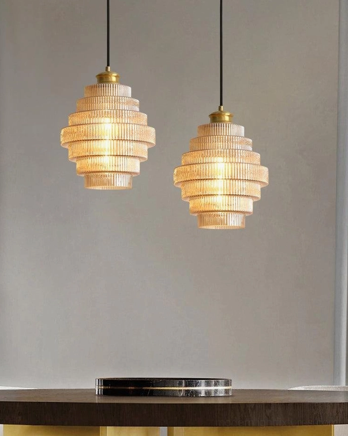 Cluster of three ridged glass pendant lights in different finishes, installation-level dining ambiance