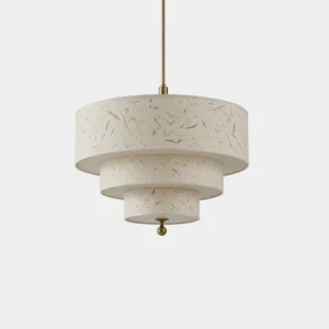 Three-tier cascading drum pendant light in cream handmade fiber paper with brass-tone suspension cord and finial, studio overhead view