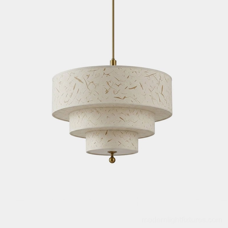 Three-tier cascading drum pendant light in cream handmade fiber paper with brass-tone suspension cord and finial, studio overhead view