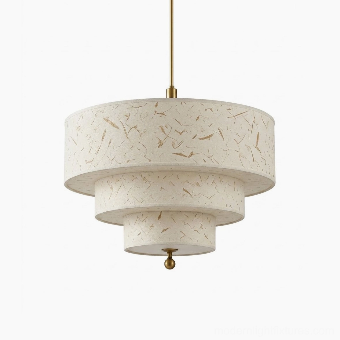 Three-tier drum pendant light studio shot from below, tiered beige shade with gold fiber flecks, brass ball finial detail
