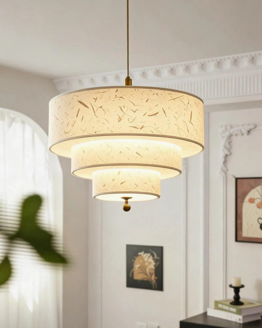 Three-tier fiber paper pendant light illuminated above dining corner, neutral warm tones, subtle gold decorative accents