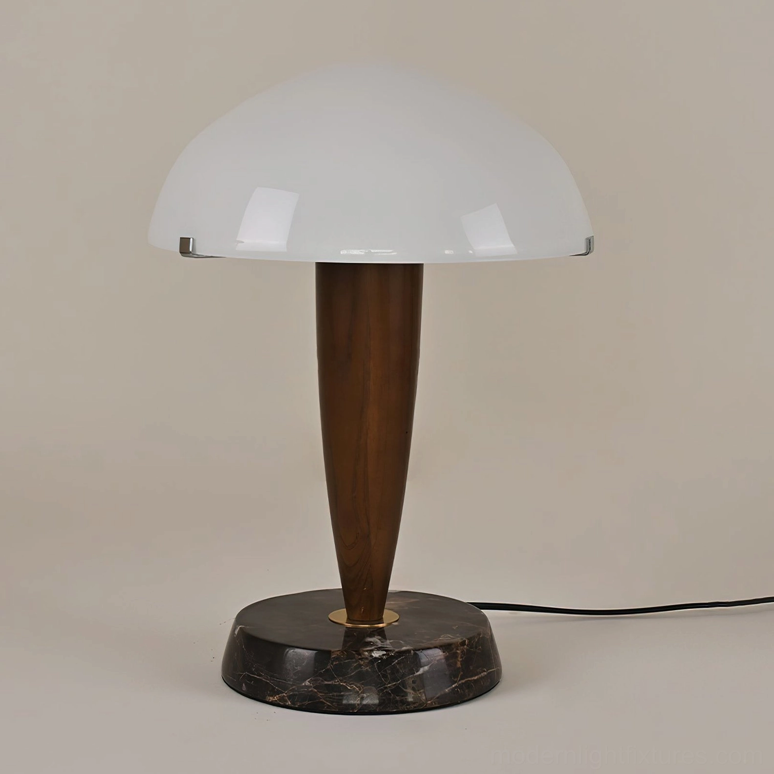 Left front view of contemporary Tibby marble table lamp showing walnut wood construction and glossy frosted glass dome on studio background