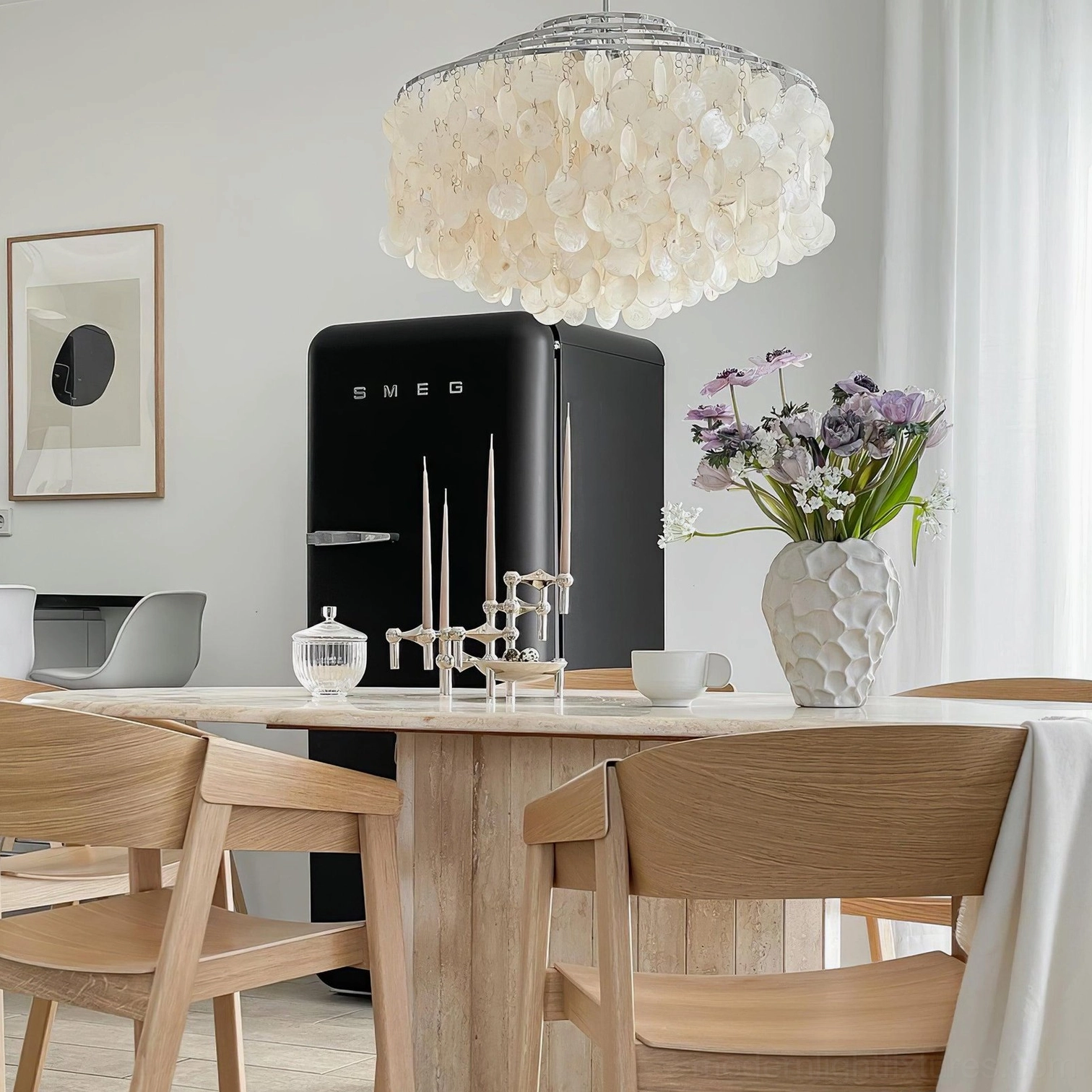 Tiered Capiz shell chandelier with chrome metal finish in contemporary home