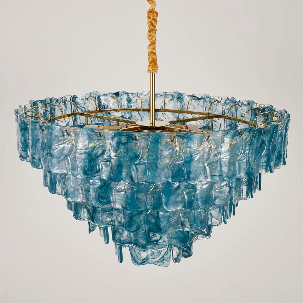 Modern tiered glass chandelier installed in contemporary interior space, showing how geometric pendant light anchors room design