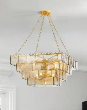 Tiered glass chandelier installed in residential entryway with gold chain suspension creating luxury lighting ambiance