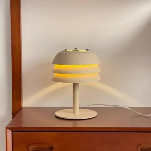 tiered table lamp on wooden bedroom nightstand warm ambient light illuminated