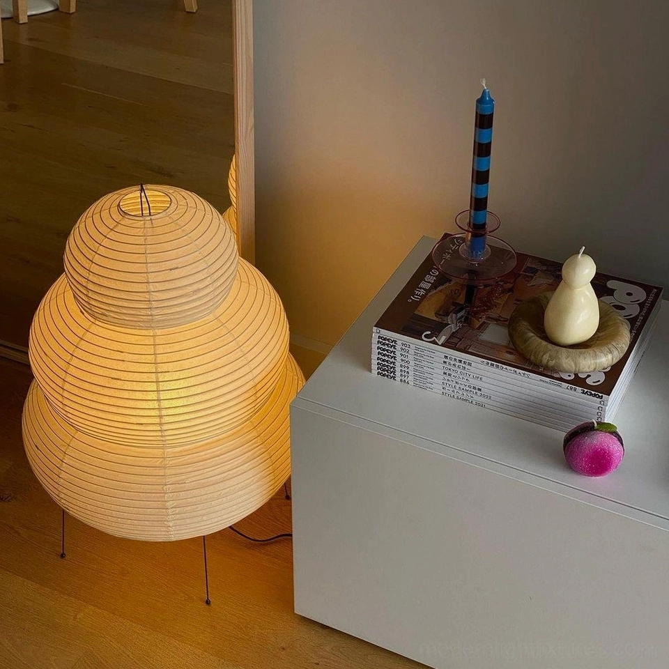 Modern sculptural tiered lamp in minimalist bedroom interior, elegant bedside lighting