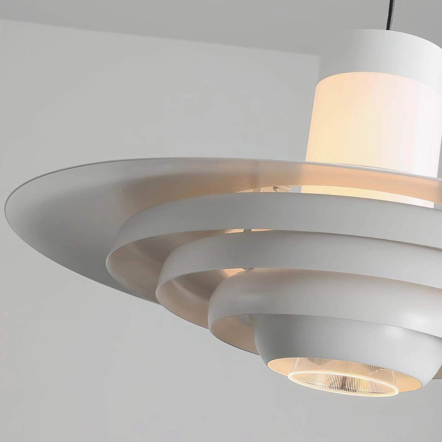 Close-up detail of layered geometric tiered pendant lamp showing stacked metal discs and frosted central light diffuser with warm glow
