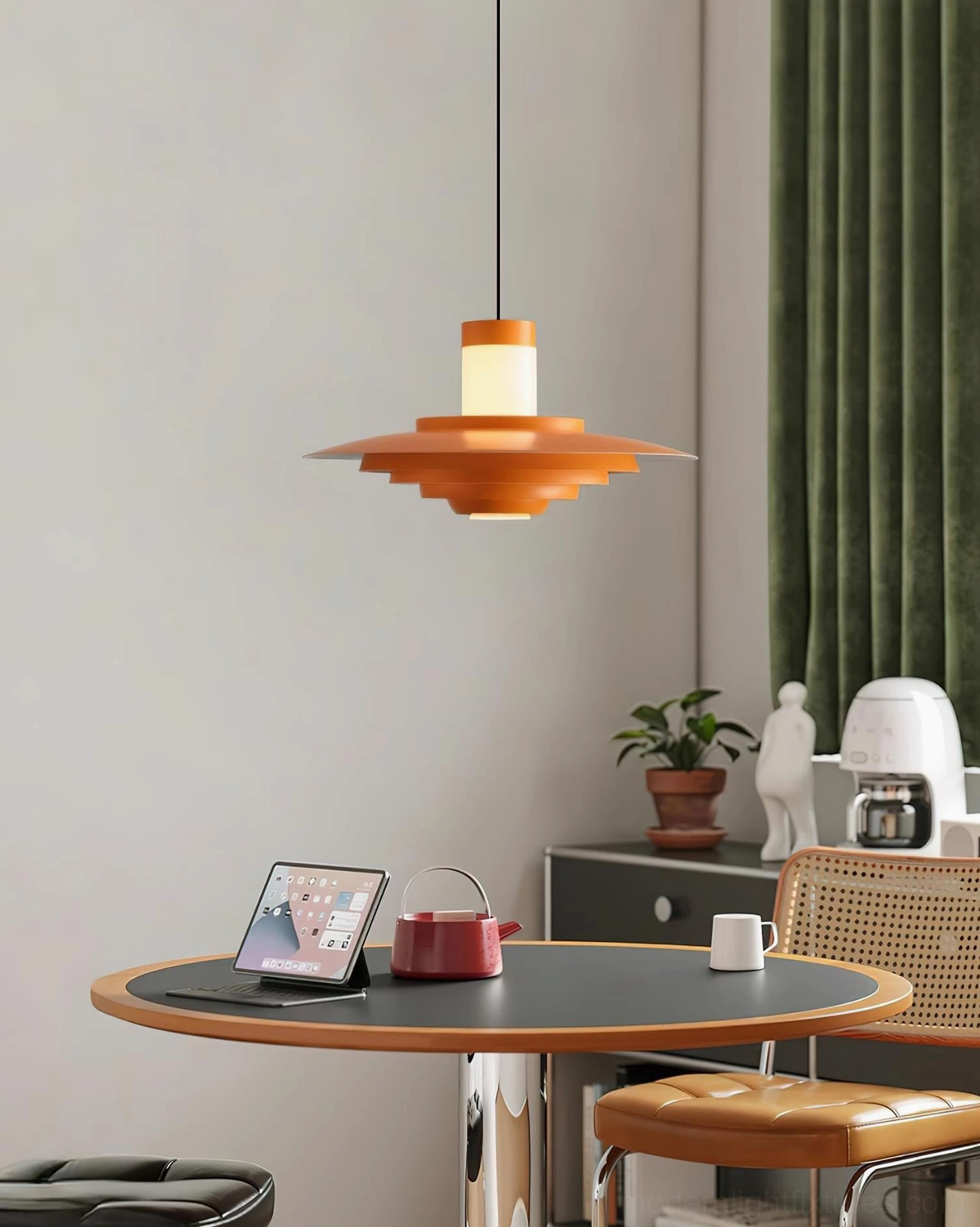 Mid-century modern tiered pendant light hanging above dining table in residential interior, warm orange tones creating ambient dining room lighting