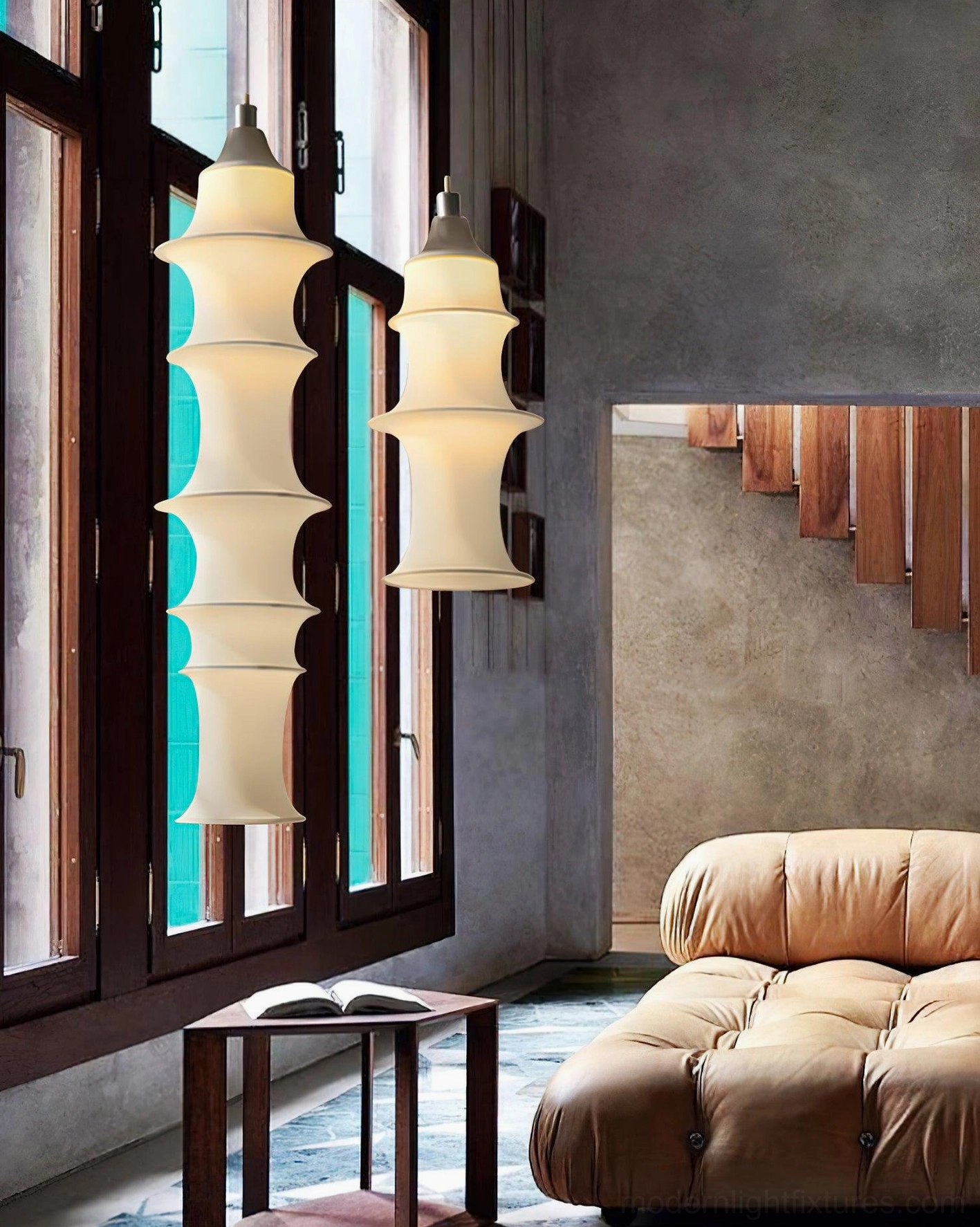 Tiered fabric pendant lamps in modern living room with floor-to-ceiling windows and warm lighting
