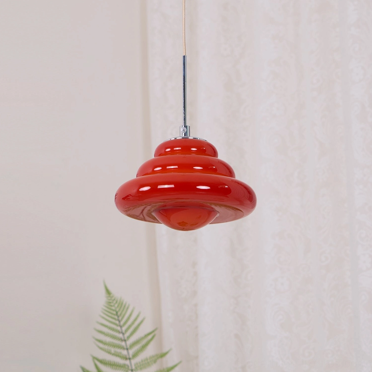 Tiered pendant light available in crimson red, pastel pink, and warm orange color options